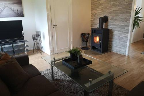 a living room with a couch and a wood stove at Reinebu in Ørsta