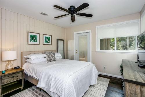 a bedroom with a bed and a ceiling fan at Lone Palm on the Bayou in Pensacola