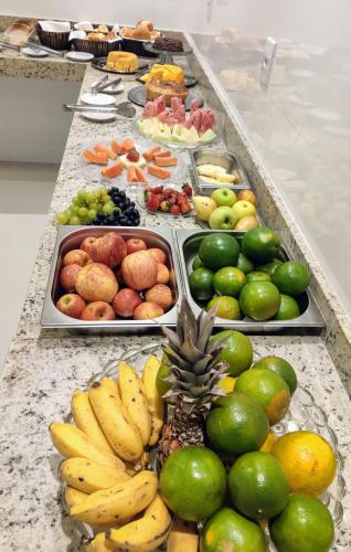 a buffet line with different types of fruits and vegetables at Nico Palace Hotel in Guanambi