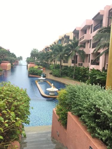 a resort pool with a boat in the water at Marrakesh Residence 325 in Hua Hin