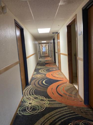 an empty hallway in a building with colorful carpet at Americas Best Value Inn Champaign in Champaign