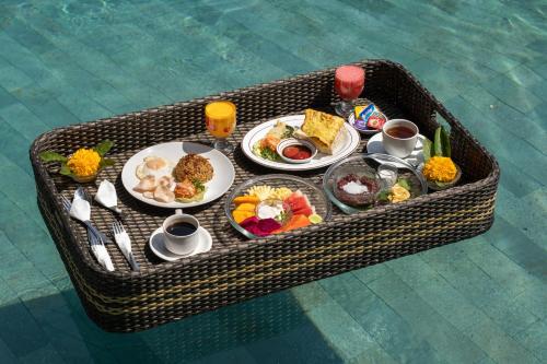 a tray of breakfast food in a wicker basket at Ketut's Place Cottage Ubud in Ubud