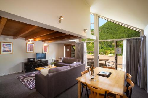 a living room with a couch and a table at Cranbury Court Apartments in Queenstown
