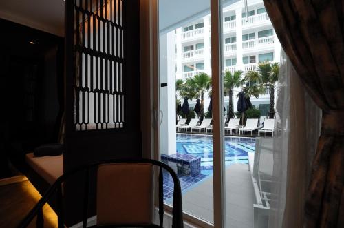 a view of a pool from a hotel room at Mövenpick Myth Hotel Patong Phuket in Patong Beach