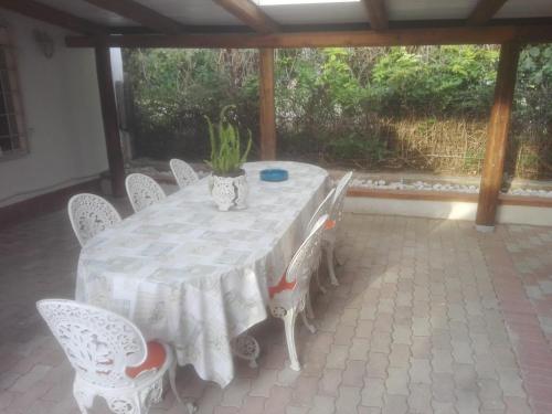 a white table and chairs on a patio at Guest House Di Bartolomeo in Capaccio-Paestum
