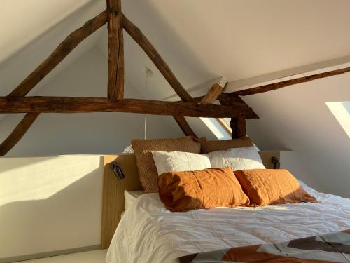 a bedroom with a bed with wooden beams at Fenêtre sur Theux in Theux