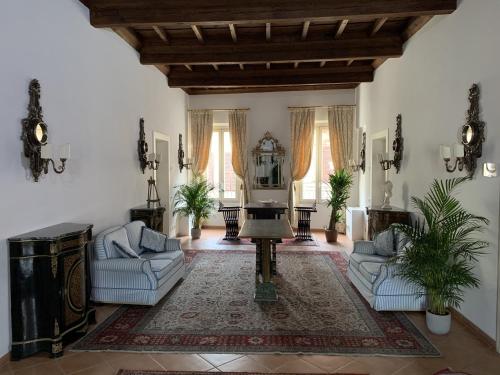 a living room with two couches and a television at Princess Art Hotel in Ferrara