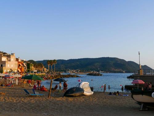 a beach with a bunch of people in the water at Pepi B&B in Santa Maria di Castellabate