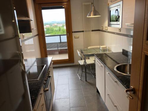 a kitchen with a counter and a sink and a window at Apartamento Mercedes in Logroño