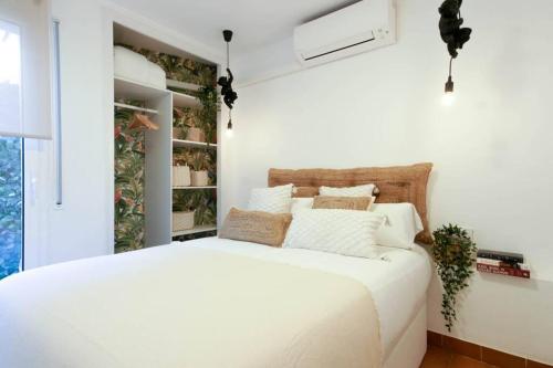 a bedroom with a large white bed in a room at EIFFEL BRIDGE BOUTIQUE APARTMENT in Girona