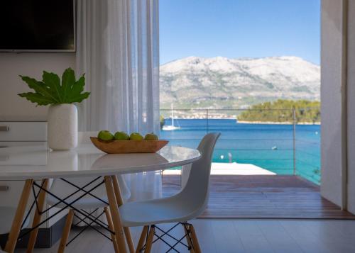 a dining room table with a bowl of fruit on it at Tara's Lodge Hotel in Korčula