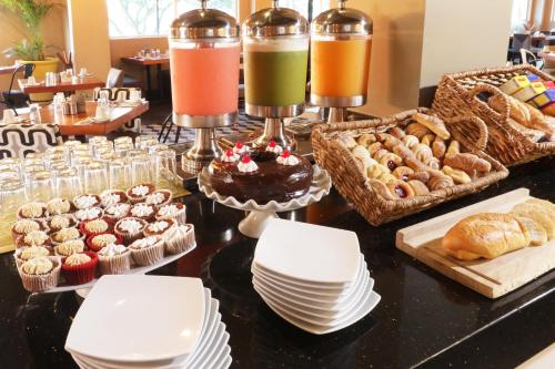 a buffet of pastries and pastries on a table at Holiday Inn Hotel & Suites Hermosillo Aeropuerto by IHG in Hermosillo