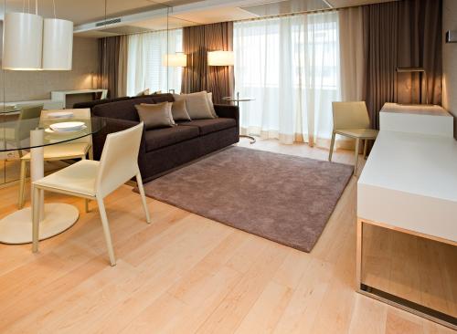 a living room with a couch and a table at Serviced Apartments Boavista Palace in Porto