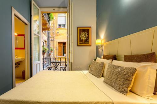 a bedroom with a large bed and a balcony at Marlin Rooms in Cagliari