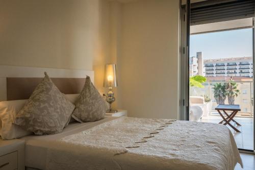 Postel nebo postele na pokoji v ubytování Apartamento Lu Ambassador