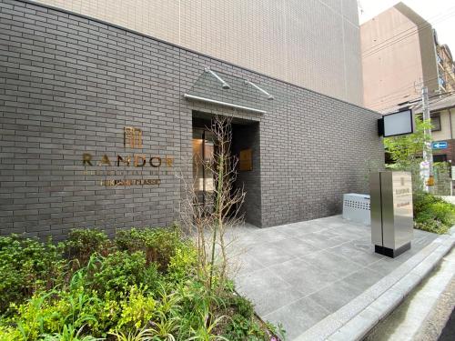 a building with a sign on the side of it at Randor Residential Hotel Fukuoka Classic in Fukuoka