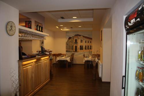 a restaurant with a bar and a dining room at Hotel Europa in Liptovský Mikuláš
