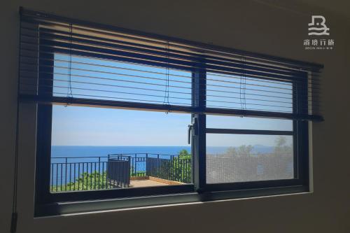 a window in a room with a view of the ocean at 濱境行旅 Begin Inn in Xiaoliuqiu