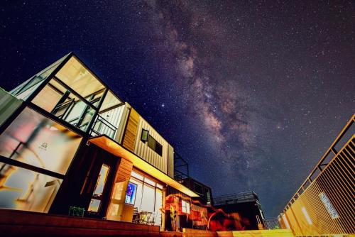 a building with the milky way in the sky at 濱境行旅 Begin Inn in Xiaoliuqiu