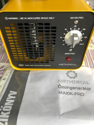 a yellow and black appliance on a display shelf at Ádám Apartman in Balatonföldvár