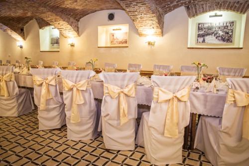a set up for a wedding with bows on chairs at Hotel Europa in Liptovský Mikuláš