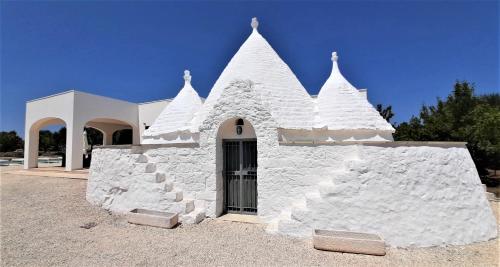 a white building with spikes on the side of it at Trullo Tranquillo Ostuni in Ostuni