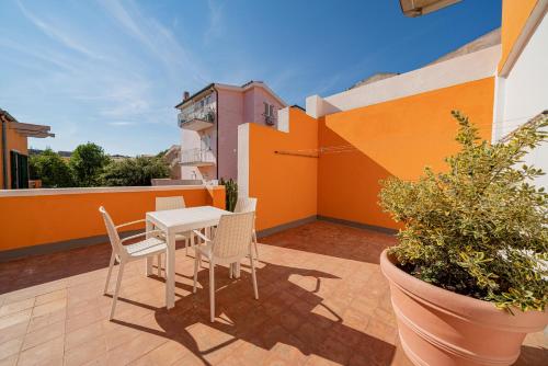 a patio with a table and chairs on a balcony at Hotel Marinaro in Santa Teresa Gallura