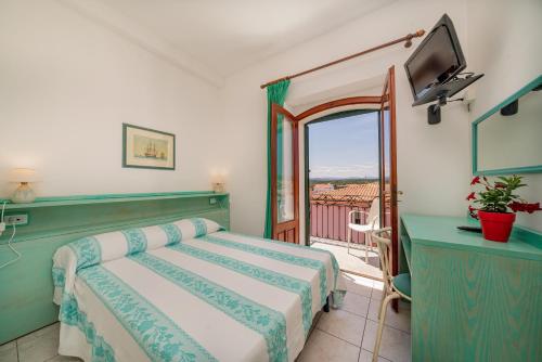 Säng eller sängar i ett rum på Hotel Marinaro
