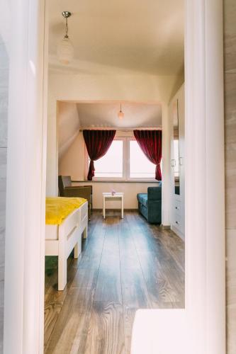 a bedroom with a bed and a couch and a window at Apartmani Markešić Ramsko jezero in Prozor