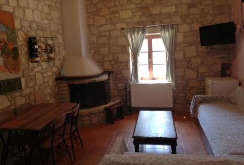 a living room with a couch and a fireplace at Saint George in Kalavrita