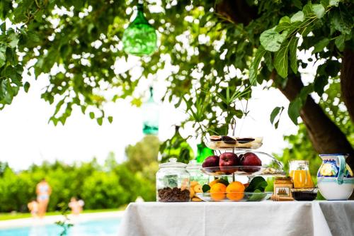 a table with fruit and other food on it at Terre e Torri Country Resort in Lascari