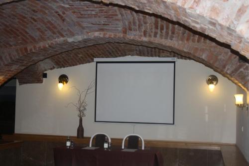 a white screen in a room with a brick wall at Hotel Europa in Liptovský Mikuláš