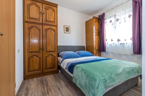 Postel nebo postele na pokoji v ubytování Rooms and Apartments Budiša