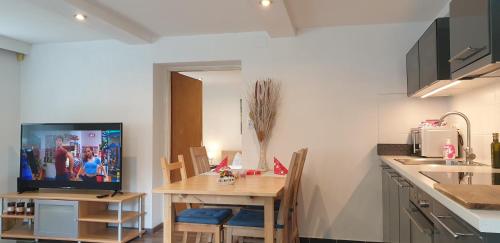 a kitchen with a table with a television on it at Apartements Breitenwang in Reutte