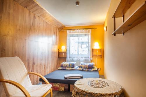 a room with a bed and a table and a window at Pěkná Vyhlídka in Závažná Poruba