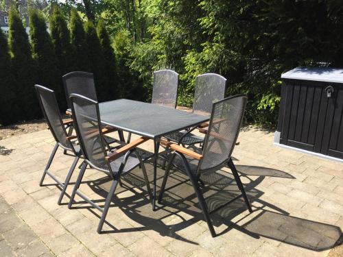 a table and four chairs sitting on a patio at Charmante Ferienwohnung mit Sauna und Terrasse in Winterberg