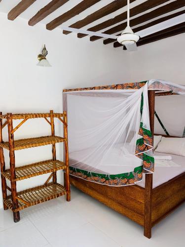 a room with two beds and a ladder at Zava Nungwi in Nungwi