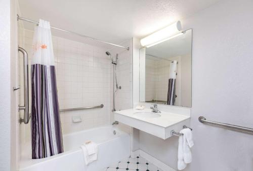 a white bathroom with a sink and a shower at La Quinta Inn by Wyndham El Paso West in El Paso