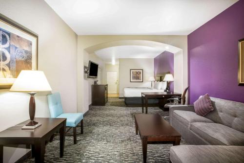 a hotel room with a couch and a bed at La Quinta by Wyndham Kyle - Austin South in Kyle
