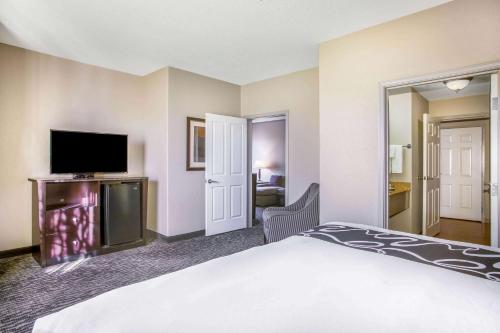 a hotel room with a bed and a flat screen tv at La Quinta by Wyndham Kyle - Austin South in Kyle