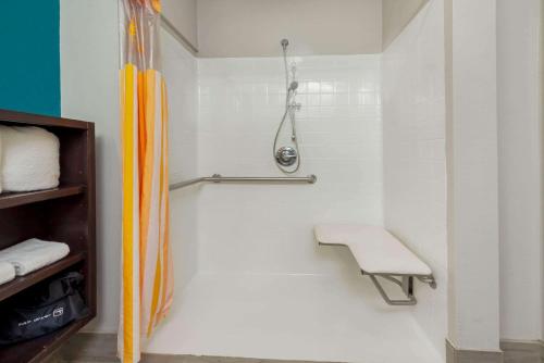 a shower stall with a bench in a bathroom at La Quinta by Wyndham Houston Humble Atascocita in Humble