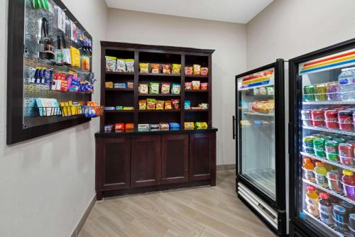 a store room with a refrigerator with food at La Quinta by Wyndham Houston Humble Atascocita in Humble