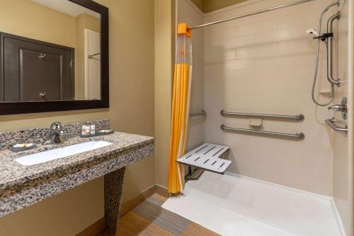 a bathroom with a tub and a sink and a shower at La Quinta by Wyndham Muskogee in Muskogee