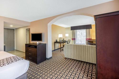 a hotel room with a bed and a television at La Quinta by Wyndham Denison - North Lake Texoma in Denison