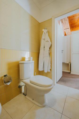a bathroom with a white toilet in a room at Premier Geneva Hotel in Odesa