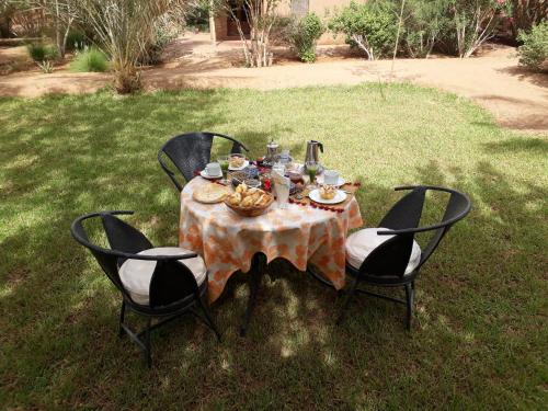 a table with food on it in the grass at Dar Paru in Mhamid