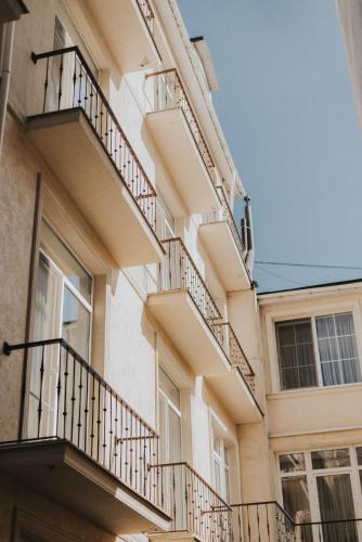 a building with balconies on the side of it at Premier Geneva Hotel in Odesa
