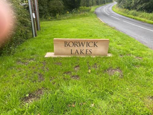 a sign on the side of a road at lake view staycations in Carnforth