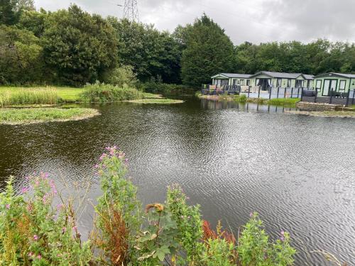 a row of houses on the side of a river at lake view staycations in Carnforth