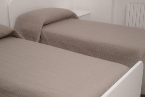 a close up of a bed and a couch at LA Dimora di Maria in Laterza